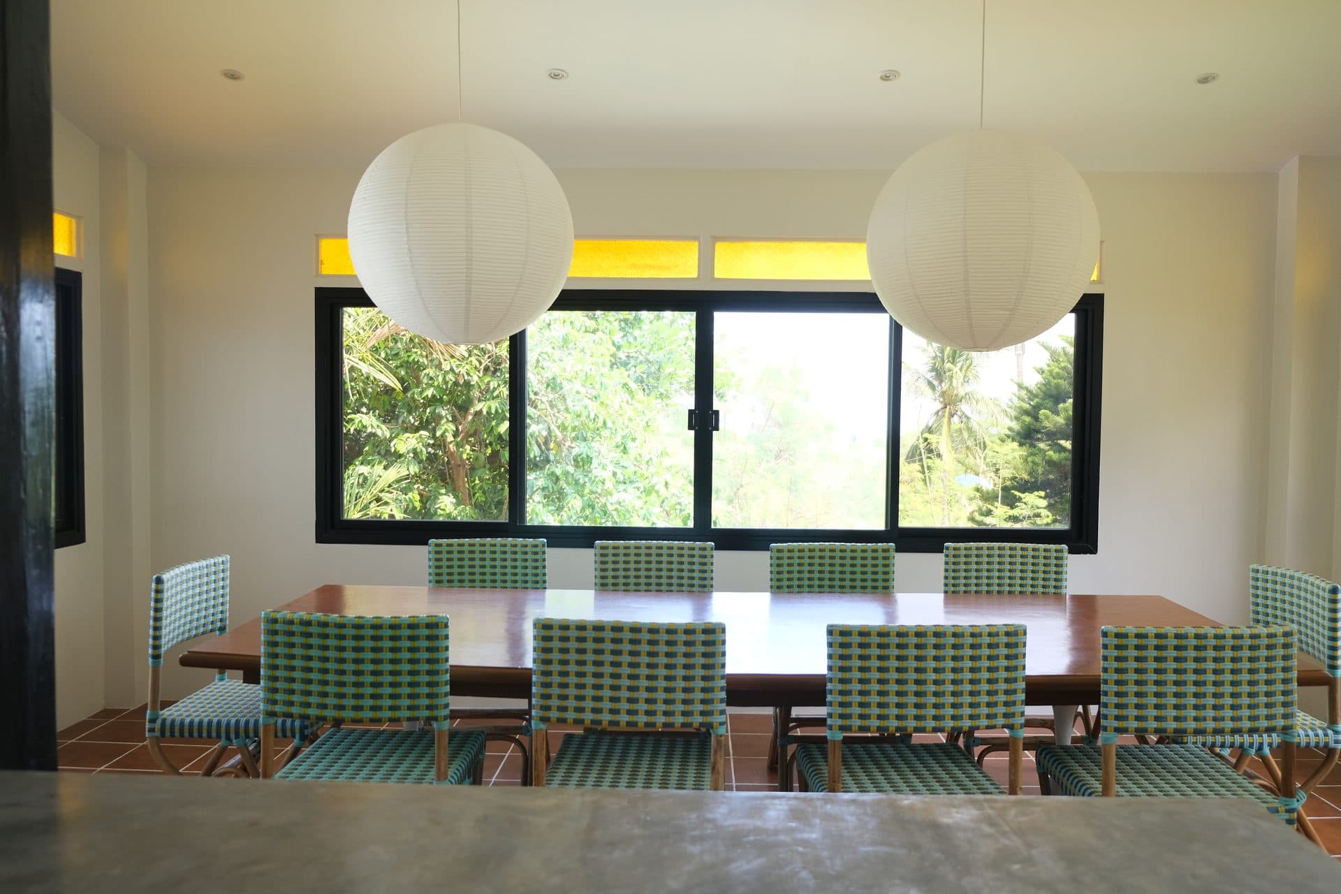 Balay sa Pansol dining room with 10-seater table and artisan pendant lights