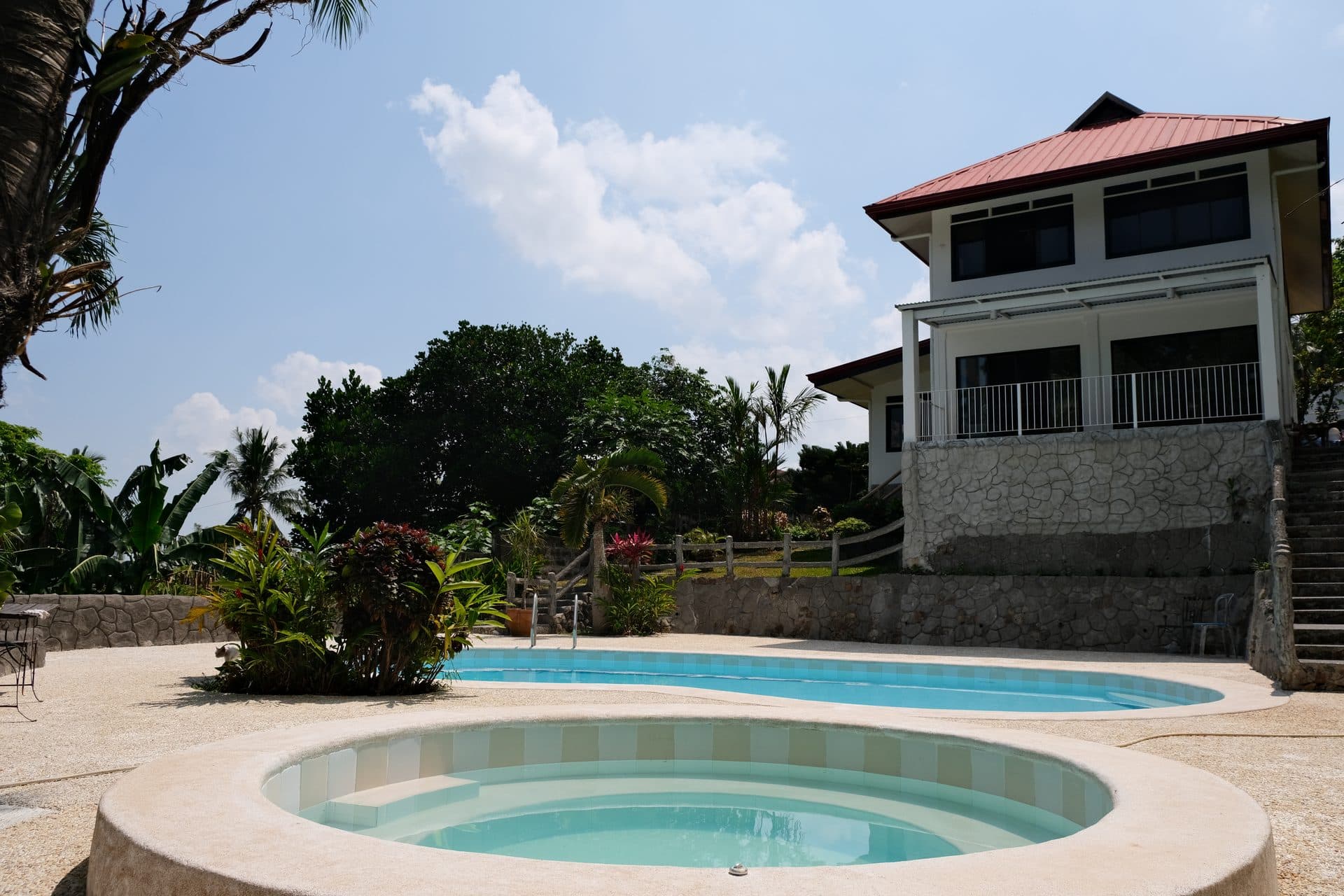 Balay sa Pansol private outdoor pool and jacuzzi area with tropical green surroundings