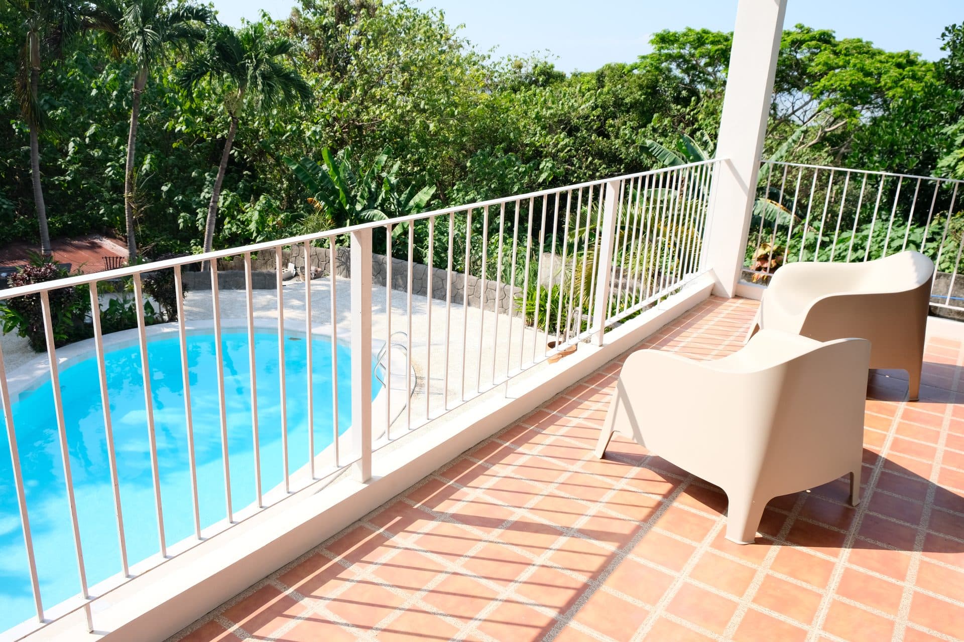 Balcony lounge area overlooking pool